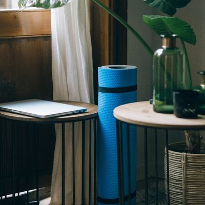 A minimalist room with natural light and a yoga mat.