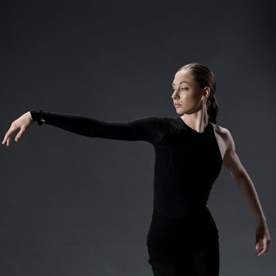 A person in a fluid yoga pose, captured mid-motion.